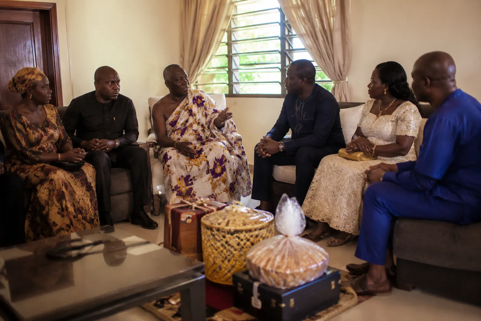 Ghanaian family elders and representatives seated for a customary engagement discussion